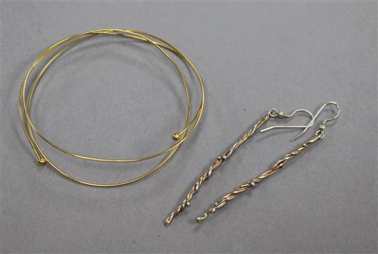 An 18ct gold bangle and a pair of parcel gilt silver spiral twist earrings.